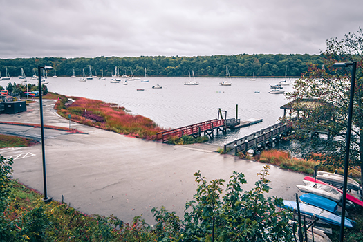A view of the boat landing, docs, boats, and water at the East Greenwich Yacht Club