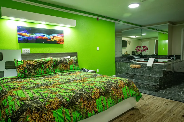 The Jacuzzi room from the door, with the bed in front and the Jacuzzi to the right