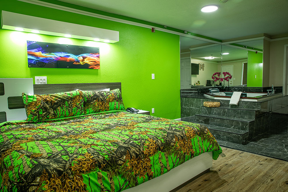 View of the jacuzzi room from the door. A closeup of the bed with the jacuzzi to the right.